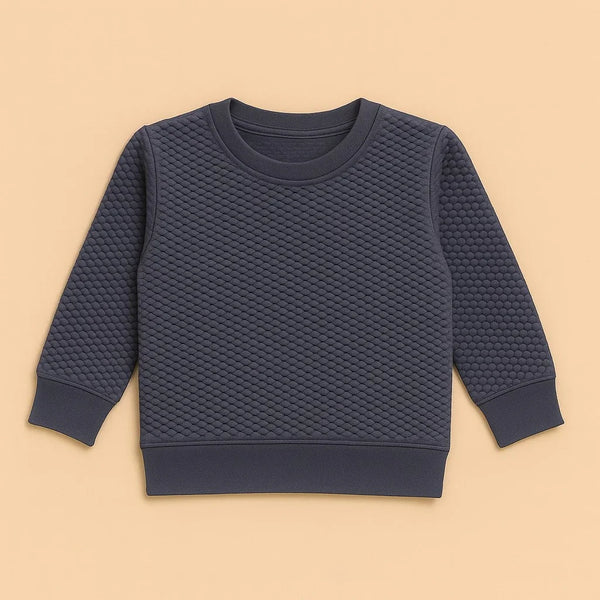 Charcoal quilted knit sweatshirt with diamond texture and ribbed cuffs on beige background