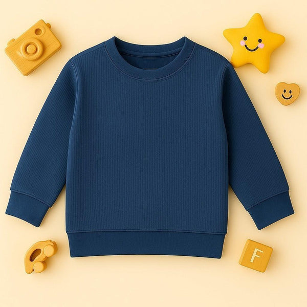 Zinc blue knitted pattern children's sweatshirt with ribbed cuffs on cream background with wooden toys